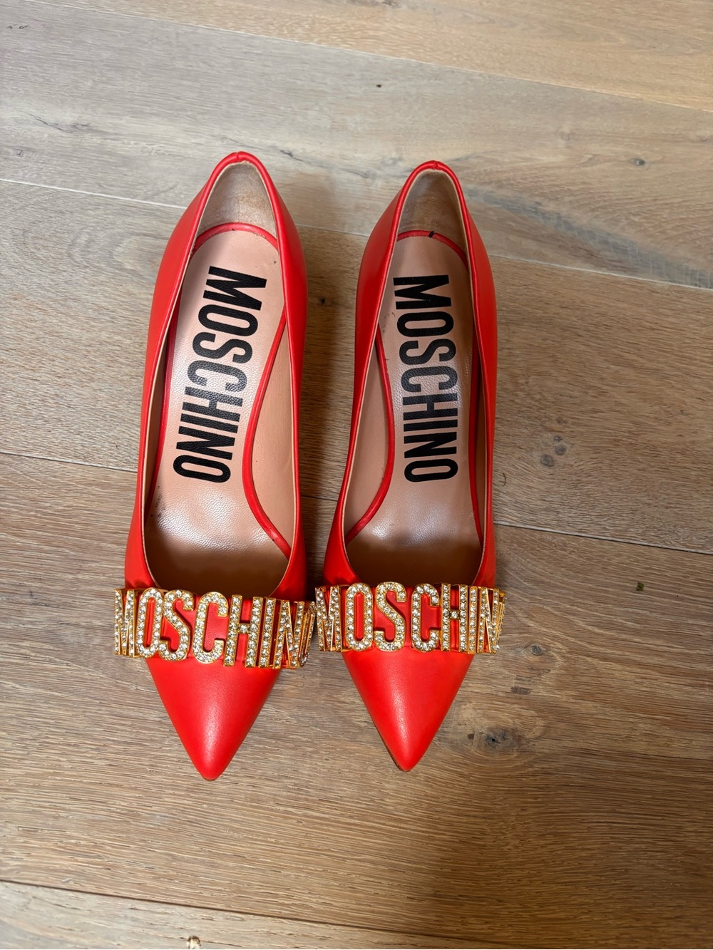 Moschino Red Pointed Toe Logo Pumps with Gold Crystal MOSCHINO Plaque